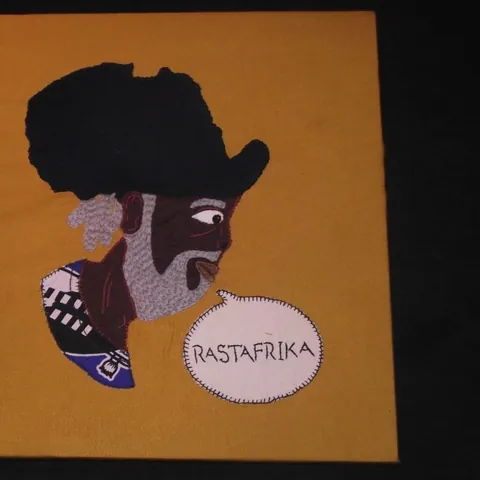 A yellow shirt printed with a portrait inside the shape of Africa
