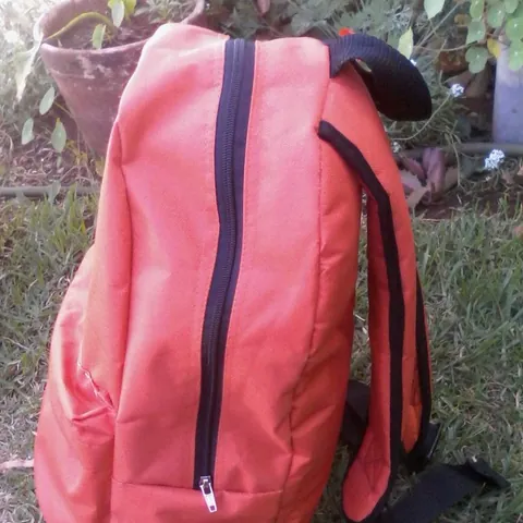 A coral-pink backpack
